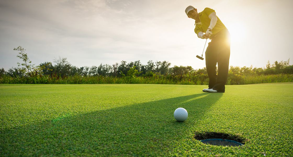 Man with golf club and golf ball